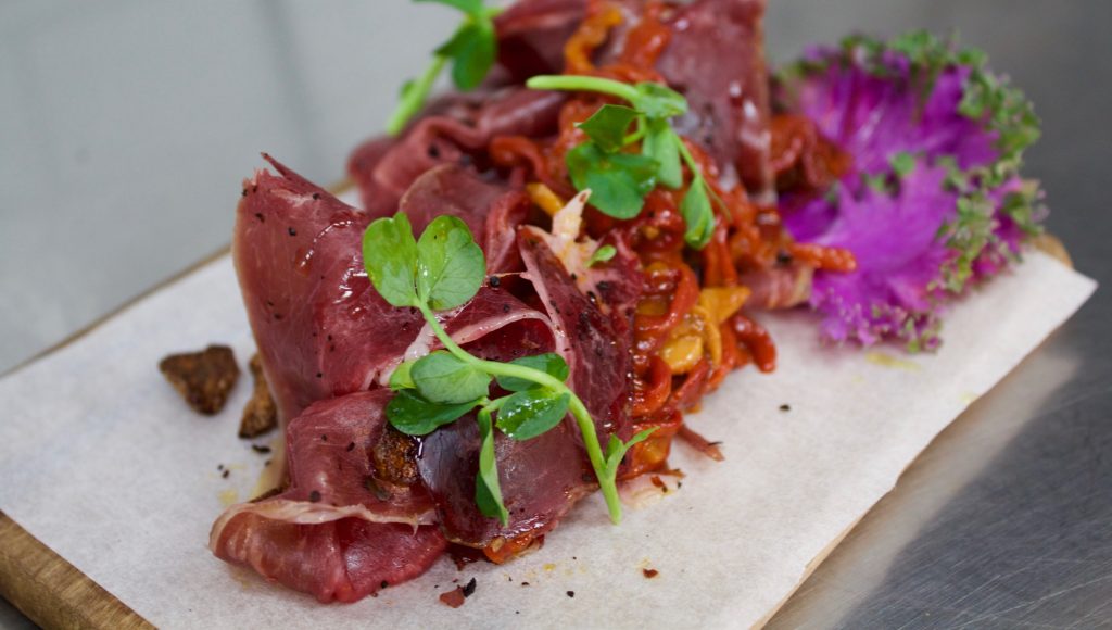 Cecina smoked beef, piquillo peppers, crispy garlic at NOPI